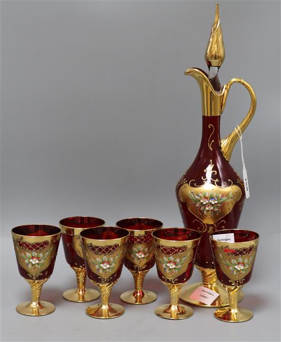 A Bohemian ruby glass and gilt claret jug and six glasses